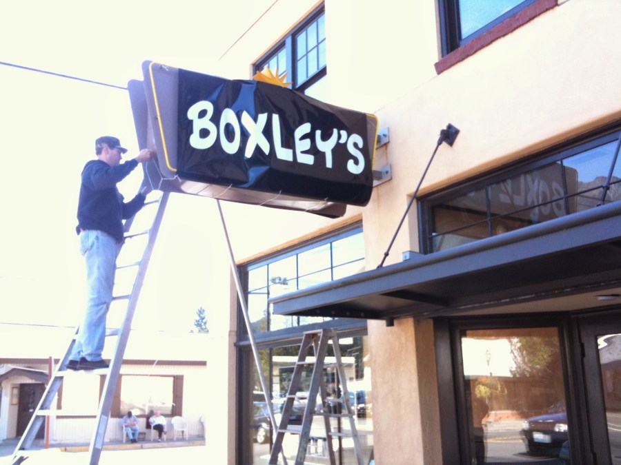 Ray helping hang the temporary sign